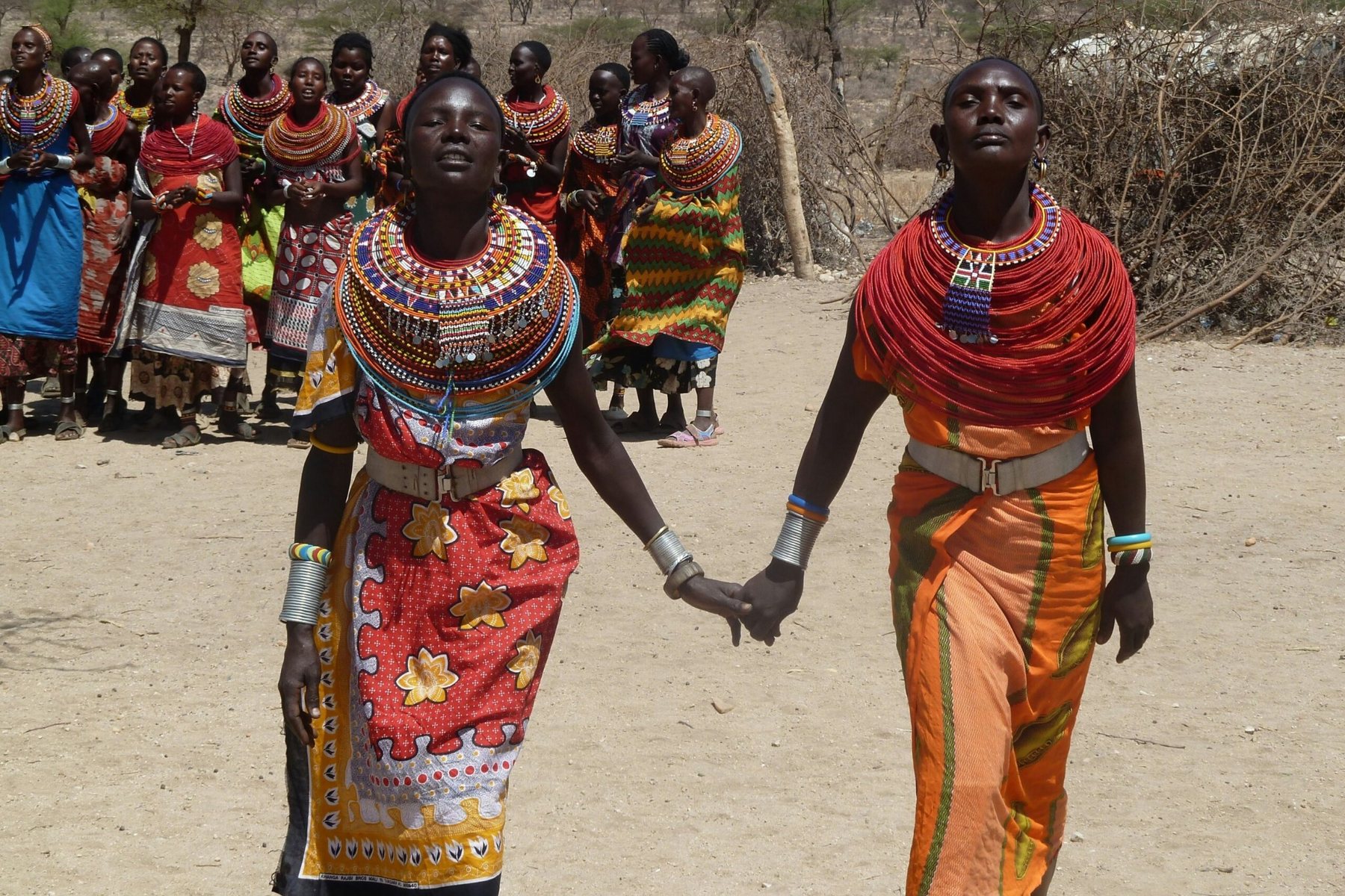 Women in colorful traditional attire taking part in a community cultural gathering