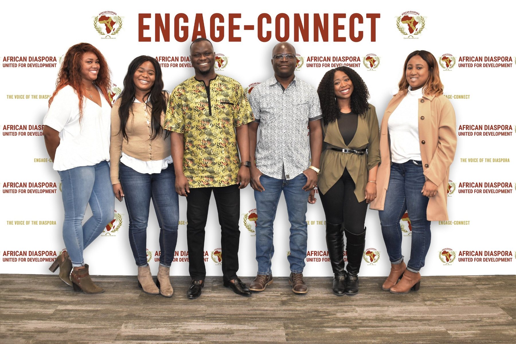 Engage-Connect participants and facilitators standing in front of the event backdrop