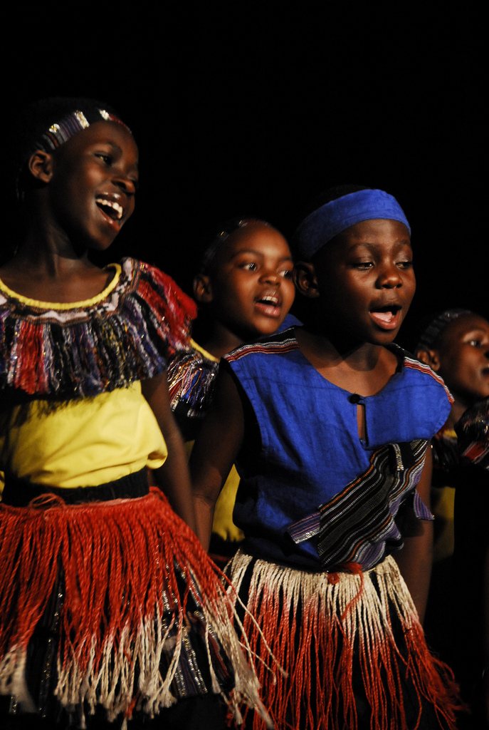 Children performing in colorful African cultural clothing